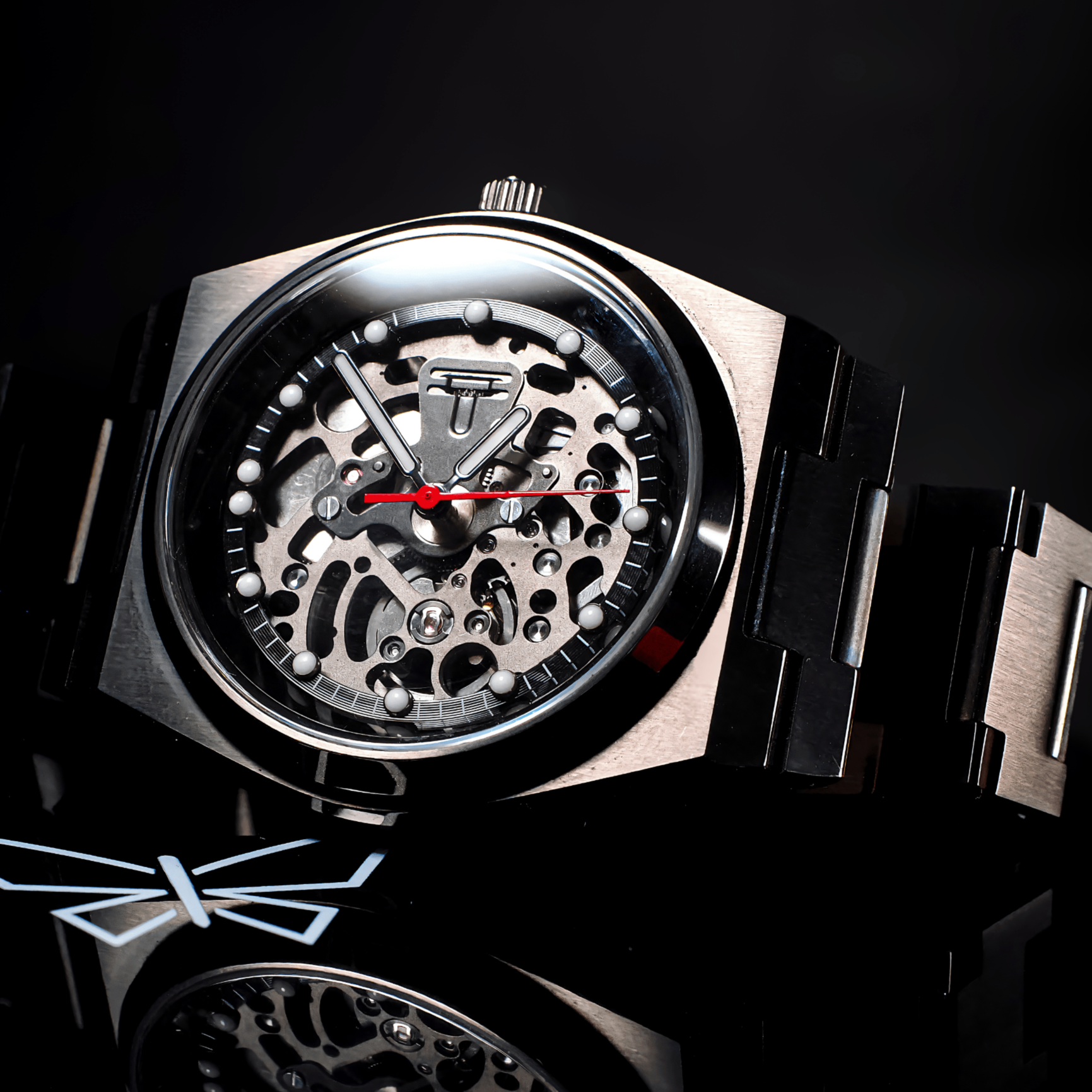 Luxury watch with a black strap on a reflective surface
