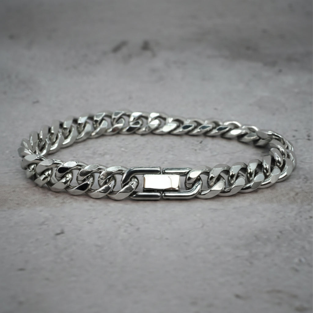 Front view of a silver Cuban Bracelet on a grey counter.