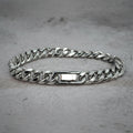 Front view of a silver Cuban Bracelet on a grey counter.