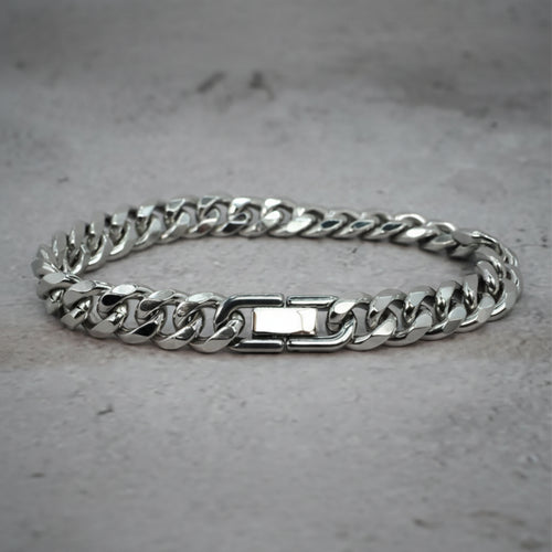 Front view of a silver Cuban Bracelet on a grey counter.