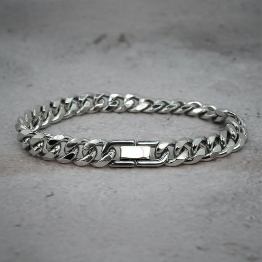 Front view of a silver Cuban Bracelet on a grey counter.